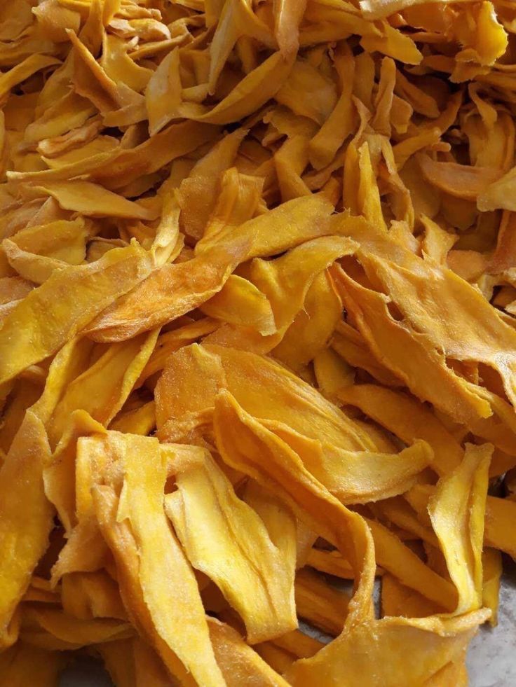 Golden dried mango slices on cream linen